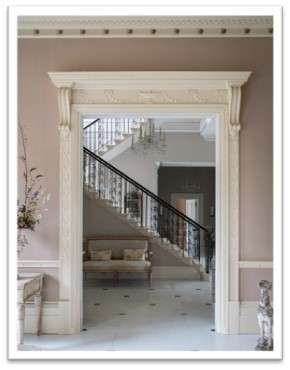 Hallway walls painted in white paint with hints of pink 